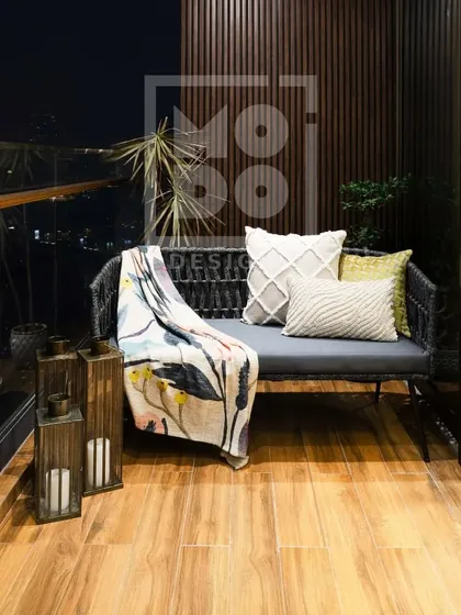 This cozy balcony is the perfect spot to unwind. We used comfortable seating, a stylish throw, and lantern-style candle holders to create a serene oasis for morning coffees or evening relaxation.