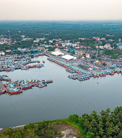 The bustling Malpe fishing harbour in Udupi, seen from above. The frame is filled with hundreds of colourful fishing boats, showing the scale of the local marine industry.