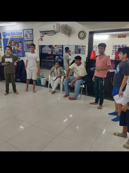 A group of students during a theatre rehearsal, working through a scene. This is where they experiment with different line deliveries and physical actions to bring their characters to life.