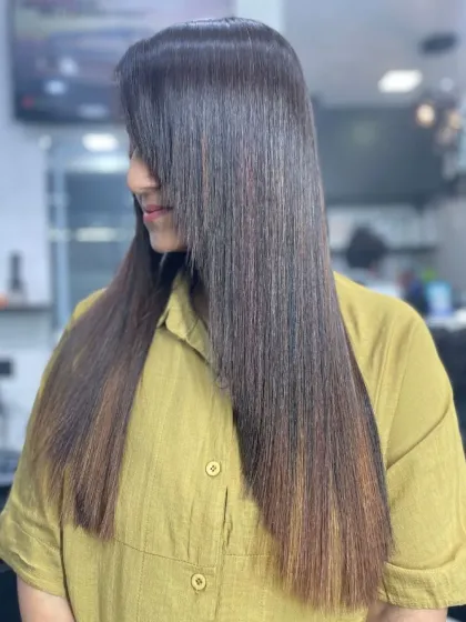 A stunning example of very long, straight hair with a subtle color gradient, showcasing a healthy, glass-like shine.