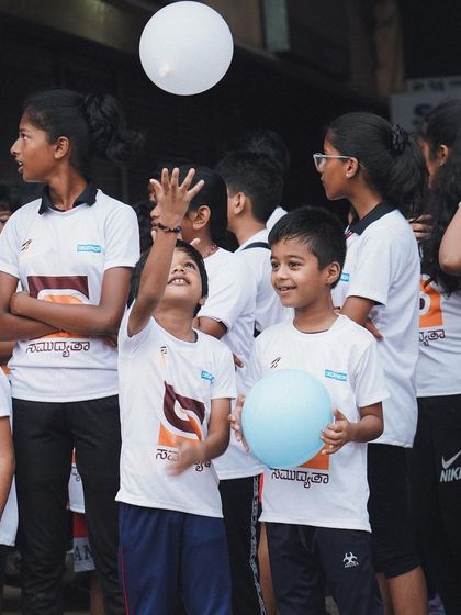 The joy of participation. Two young boys having fun with balloons at the Kids Walkathon event.