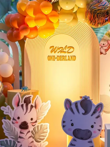 A closer look at the 'Wild ONE-derland' backdrop, featuring cute zebra cutouts and a warm, glowing arch that creates a perfect photo opportunity.