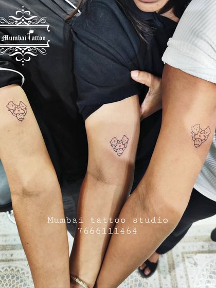 A heartwarming tattoo for a trio of friends, featuring three little bears huddled together in a heart shape. This is a perfect symbol of a tight-knit group.