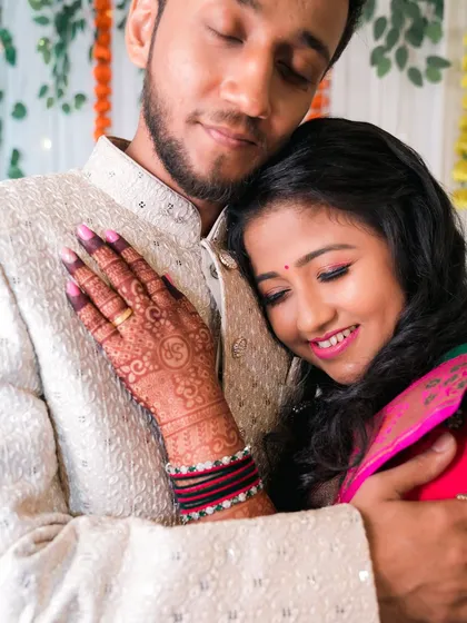 A tender moment with the bride resting her head on the groom's chest.