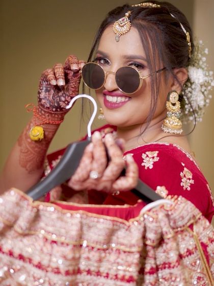 That perfect Bollywood moment. Our bride is all smiles, looking cool and confident with her fun sunglasses and flawless bridal makeup.