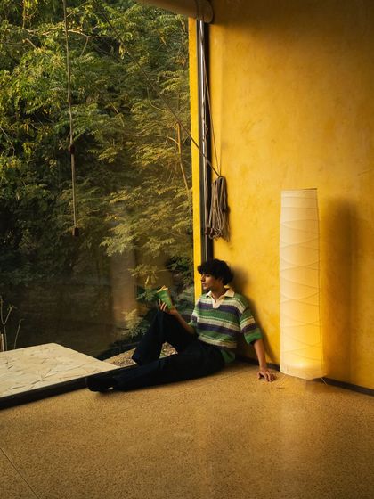 Finding your own quiet corner. A guest relaxes in a sunlit nook, a perfect example of the peaceful solitude you can find at Anvaya.