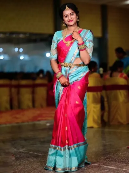 Archana at a festive event, her vibrant saree making her the center of attention.