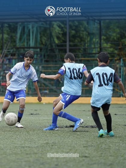 Teamwork in action. Players in training bibs work together to press and win back the ball, a key part of our tactical coaching.