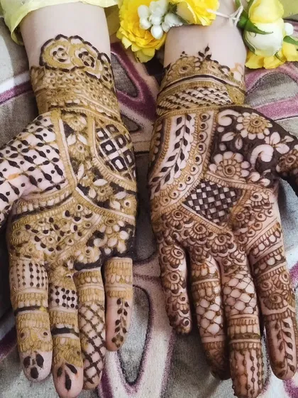 A detailed guest mehendi design. The yellow flowers add a lovely touch, showing how fresh flowers can accessorize your henna for an event.
