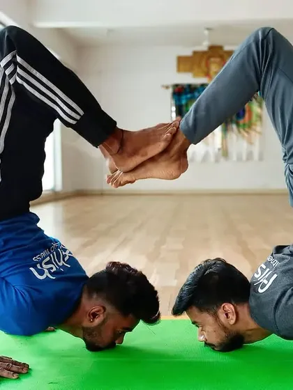 This partner arm balance requires both students to have incredible strength and focus, mirroring each other's movements perfectly.