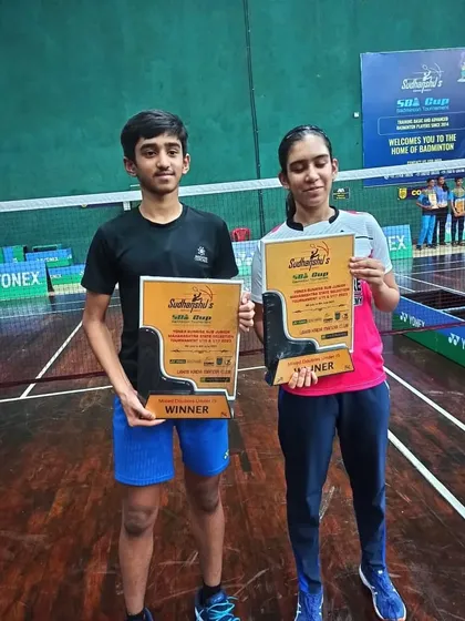 Harshit Mahimkar and his partner holding their winners' plaques for the U-15 Mixed Doubles at the Yonex-Sunrise State Selection tournament.