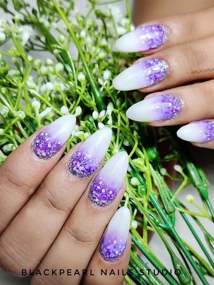 A frosty and fairytale-like design featuring a milky white to purple ombré with a heavy application of glitter. This look is perfect for winter or for anyone who loves a magical, sparkling effect.