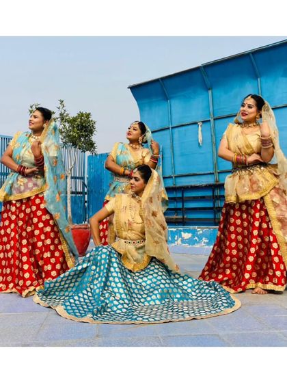 Our team of folk dancers posing in their vibrant red and blue costumes. We are ready to bring this energy to your next event.