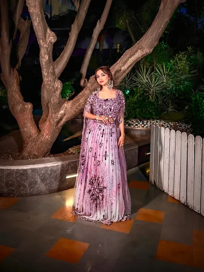 A confident pose in this beautiful lavender outfit. The makeup is kept fresh and pretty to complement the vibrant color of the dress.