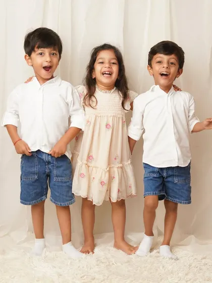 The older siblings on their own, sharing a moment of loud, happy laughter. I make sure to capture the personality of every family member during our sessions.