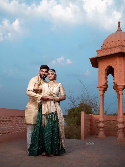 A classic couple portrait on the terrace of the rajwada. Their pose is relaxed and happy, and the beautiful architecture provides a timeless backdrop for their pre-wedding memories.