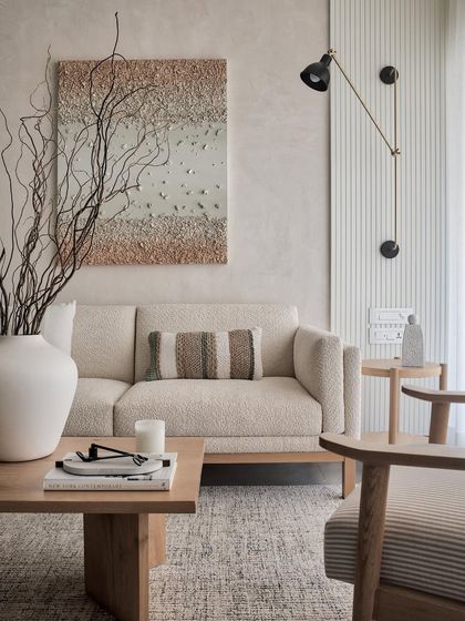 The living room is beautifully framed by a textured wall with elegant fluted panels. This detail infuses the space with character and charm, tailored specifically for a serene living experience.