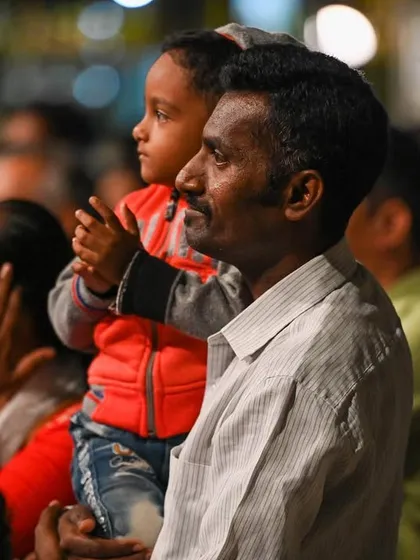 A father holding his child in the audience at the Bengaluru Ganesh Utsava. Seeing people of all ages connect with the music is the most heartwarming part of any performance.