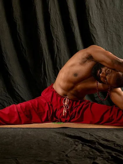 A deep seated side bend in Upavistha Konasana (Wide-Angled Seated Forward Bend). Flexibility is a process that requires patience. As you open your mind to the possibility, your body will gradually follow.