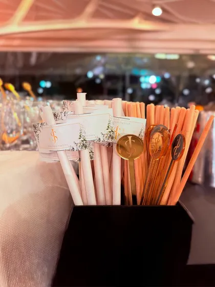 A close-up of our custom-branded straws and gold stirrers. These accessories add a touch of luxury and thoughtfulness to every cocktail we serve.