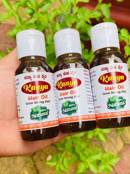 Three bottles of my homemade hair oil, ready for customers. I ensure every batch is consistent and potent.