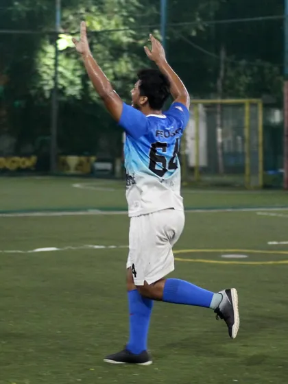The pure joy of scoring a goal. A player celebrates after finding the back of the net, showcasing the passion that drives our community.