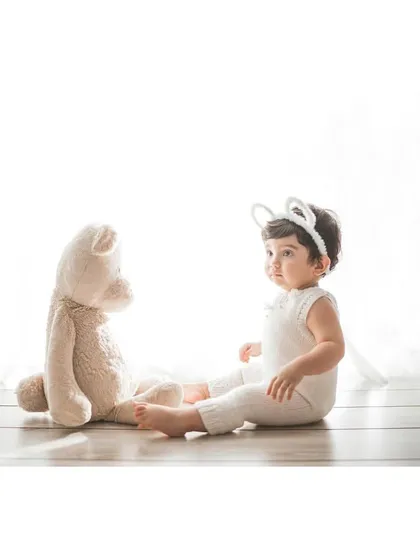 A little bunny having a chat with her teddy bear friend. Themed studio shoots like this are a wonderful way to capture your child's imagination.