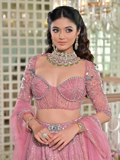 The details of this pink lehenga are exquisite. My draping style ensures the embellished blouse and belted waist are highlighted, creating a structured and flattering silhouette.