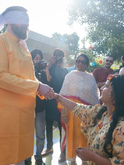 A sweet moment between the groom and a family member during the haldi rituals.
