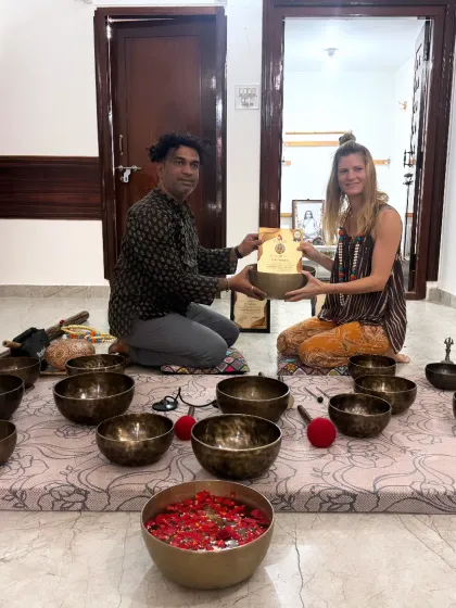 A student receives her certificate, marking the culmination of her journey in the Sound Healing course.