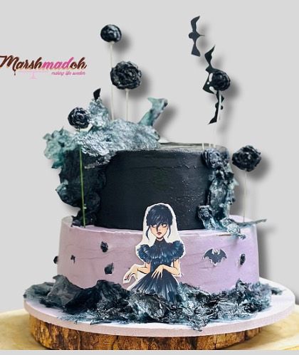 My take on a Wednesday Addams theme cake. This two-tiered design features a moody lavender and black palette, with hand-cut bats and dramatic wafer paper sails, all completely edible.