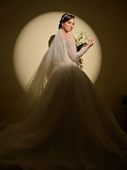 A dramatic, full-length shot of the bride in her magnificent gown, creating a truly cinematic and unforgettable image.