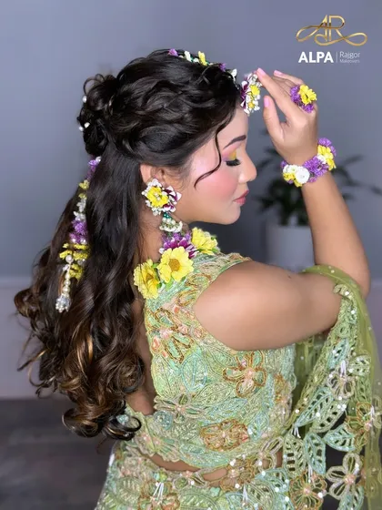 A side profile view that gives a better look at the floral earrings and the intricate hairstyle.