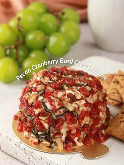 The Pecan Cranberry Basil Cheese Dome is a festival of textures and flavors. It's coated with crunchy toasted pecans and sweet dried cranberries, with fresh basil mixed into the cheese.