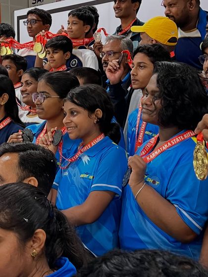 A candid moment of celebration with our new shooters, proudly displaying the 15 medals they earned at a recent competition. Their smiles reflect their hard work and success.