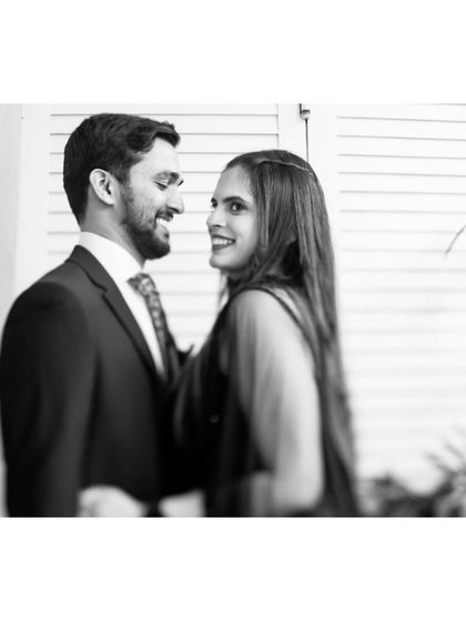 A classic black and white portrait of the couple sharing a look of love and happiness.