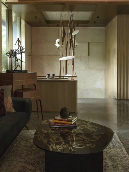 The entrance lobby staircase at the Bammi Residence, viewed from the seating area. The design integrates art, lighting, and architecture to create a welcoming and impressive entry experience.