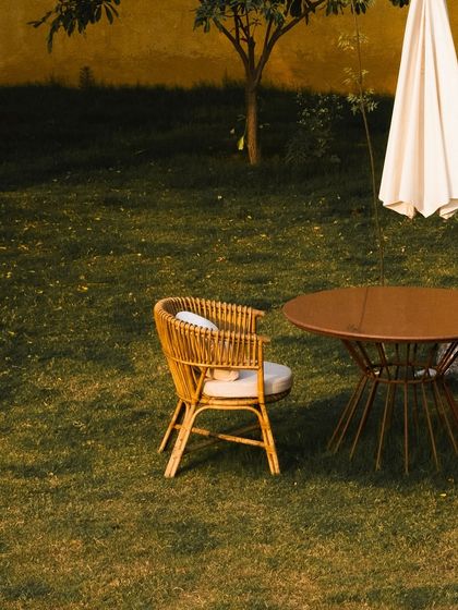 A quiet seating arrangement on the lawn, offering a private space to enjoy the garden's tranquility.