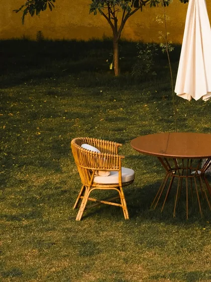 A quiet seating arrangement on the lawn, offering a private space to enjoy the garden's tranquility.