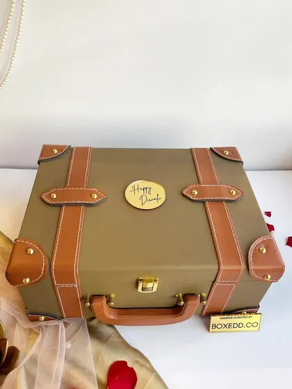 A classic leather-finish trunk box with a "Happy Diwali" seal. This packaging itself makes a statement and is a favorite for our premium corporate gifting clients.