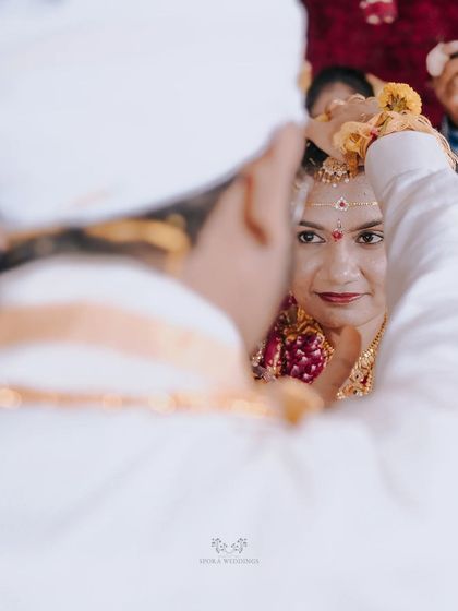 A beautiful over-the-shoulder shot of the bride looking at her groom during a key wedding ritual.