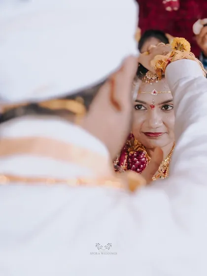 A beautiful over-the-shoulder shot of the bride looking at her groom during a key wedding ritual.