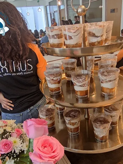 A beautiful three-tiered stand of tiramisu dessert cups at the Dextrus event. I believe that desserts should be as visually appealing as they are delicious.
