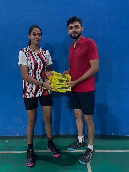 Rewarding excellence. I believe in acknowledging the hard work of my players. Here, I am presenting a new kit to one of our champions as a token of appreciation for her performance.