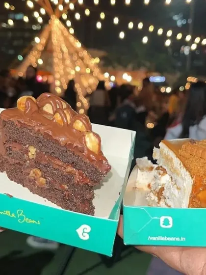 A tale of two slices. Our Nutella Hazelnut and Lotus Biscoff cakes ready to be enjoyed under the festive lights of The Lil Flea.
