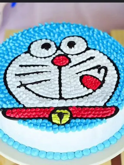 A classic Doraemon cake, perfect for fans of the beloved cartoon. The character's face is piped with buttercream, creating a fun and delicious treat.