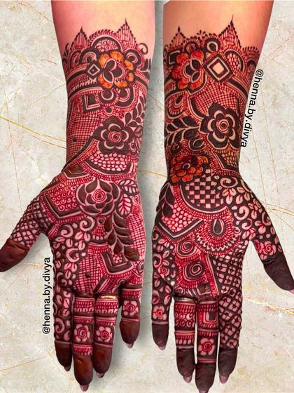 This dense bridal mehendi is a beautiful mix of floral motifs and geometric patterns like checkerboards, creating a rich and textured look that covers the hands and forearms.