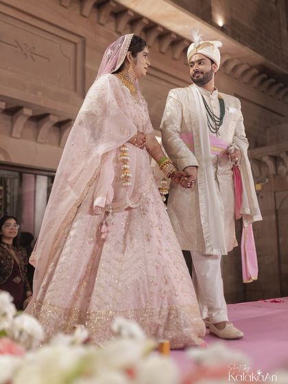 A candid moment between the bride and groom on the wedding stage, sharing a quiet look of love and understanding. These are the unscripted moments we live to capture.