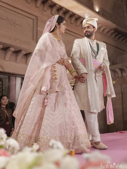 A candid moment between the bride and groom on the wedding stage, sharing a quiet look of love and understanding. These are the unscripted moments we live to capture.