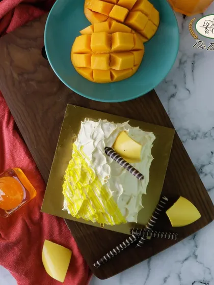 A rich and creamy mango roulade, perfect for a dinner party. This dessert features mango-infused cream rolled in a soft sponge.